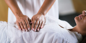 Hands on belly in reiki session